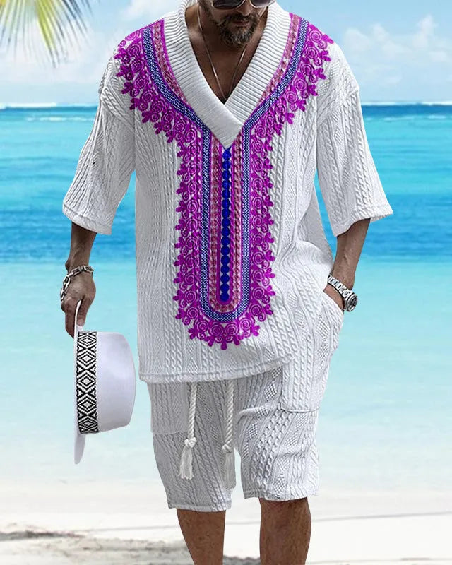 Man wearing a solid colour knitted short-sleeved top and matching shorts, showing the drop-shoulder design.