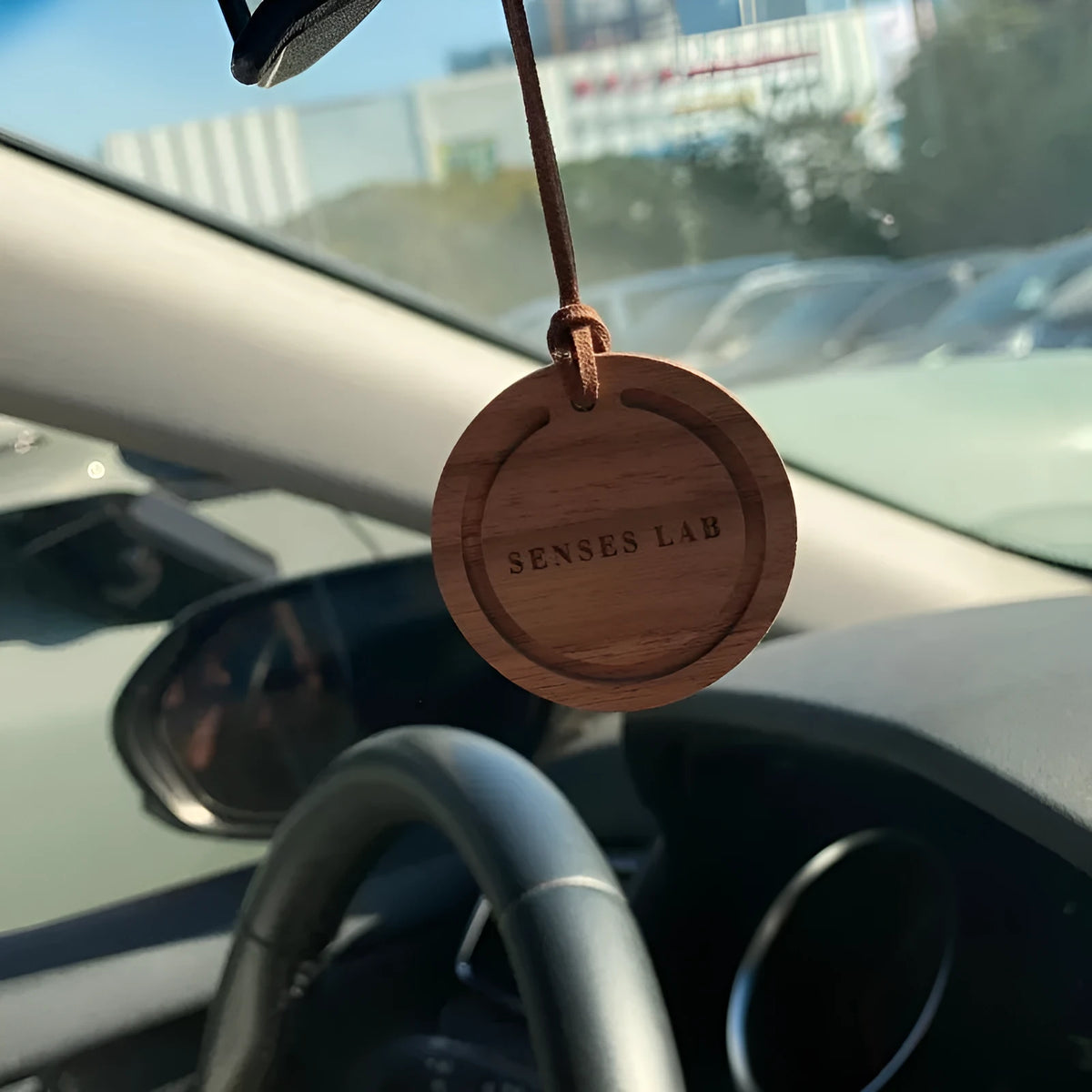 Round black walnut wood car air freshener pendant with jasmine green tea scent, 5cm diameter, brown colour variant