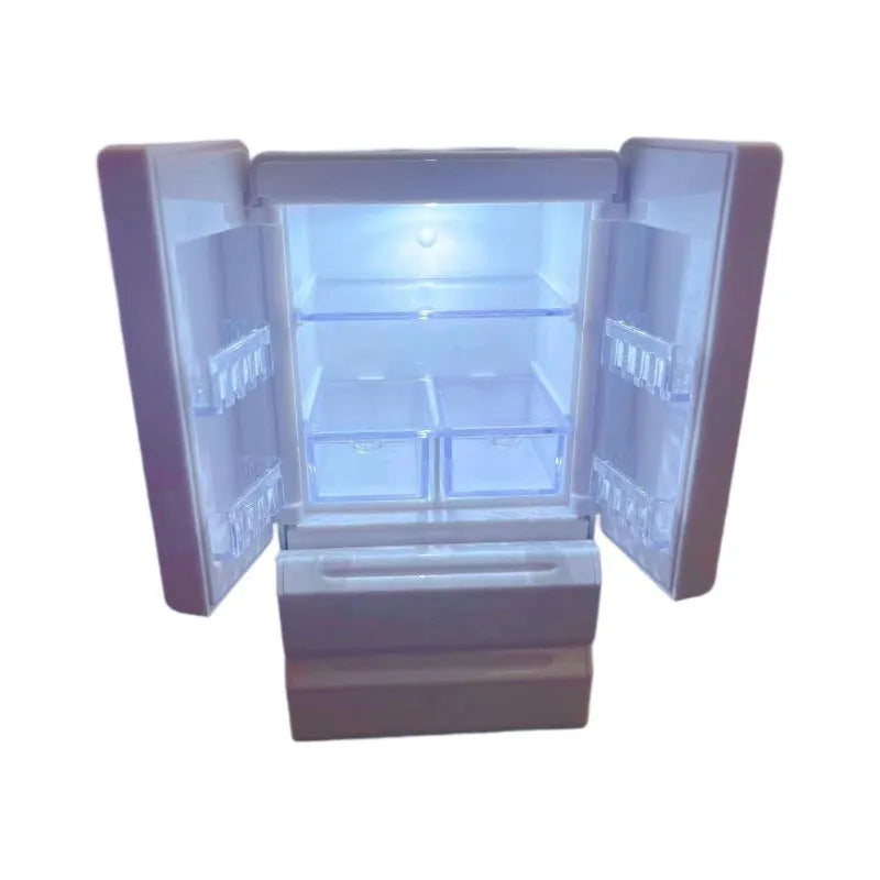 White plastic miniature candy toy model with illuminated light feature on a display surface.