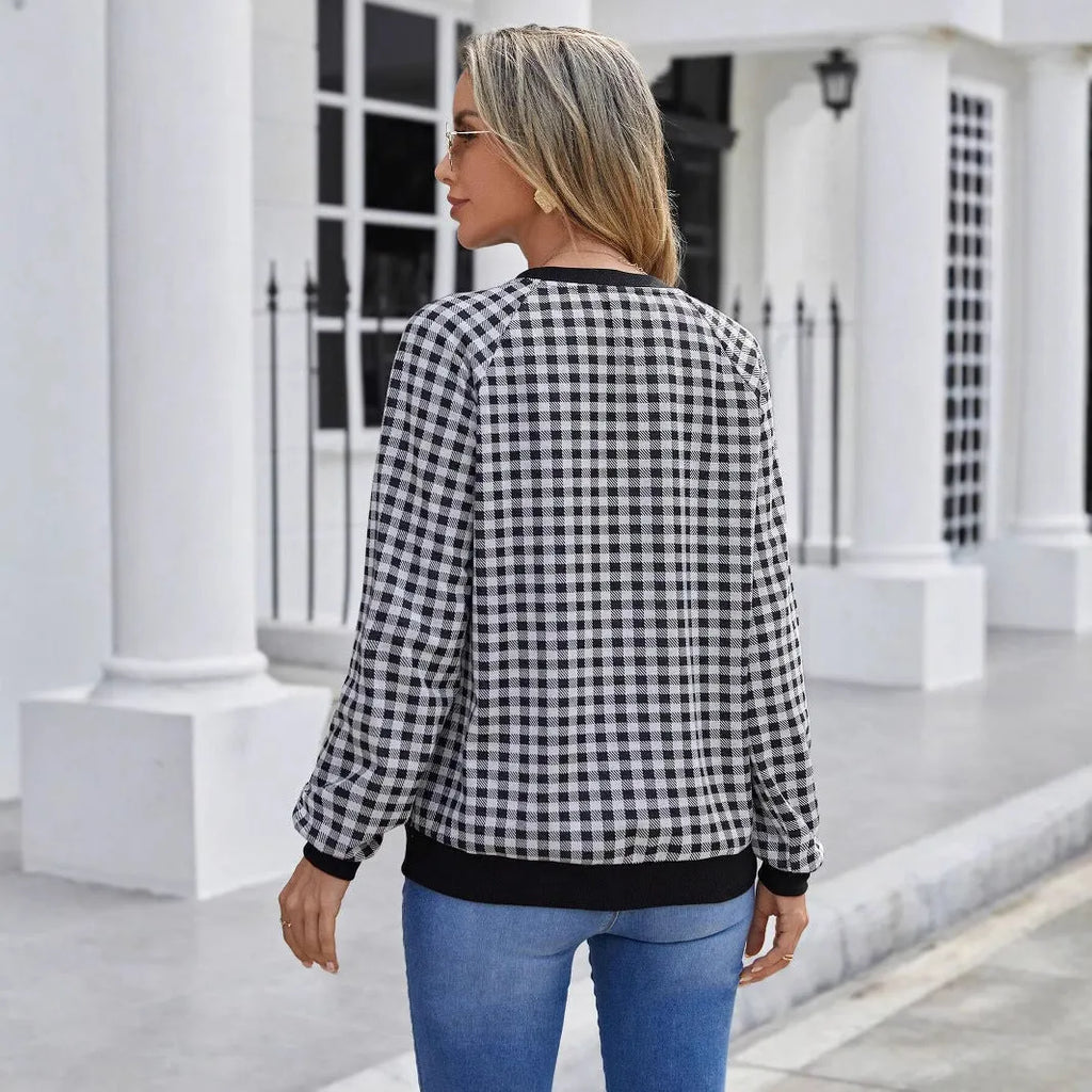 Black long sleeve pullover sweater with a printed plaid stripe pattern on a mannequin.