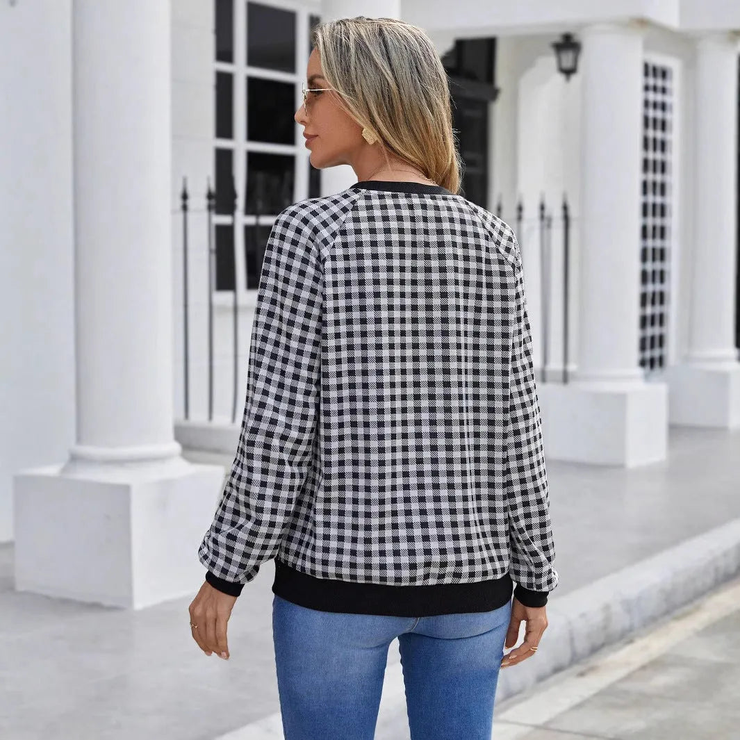 Black long sleeve pullover sweater with a printed plaid stripe pattern on a mannequin.