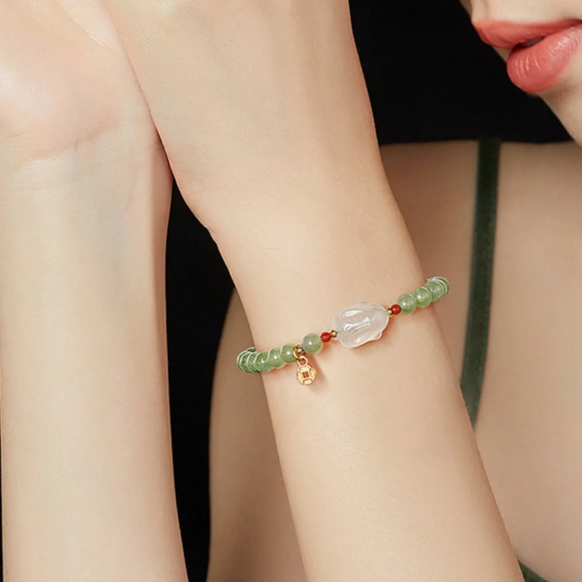 Handmade Hetian jade rabbit bracelet for women in glass with sweet rabbit charm on wrist.