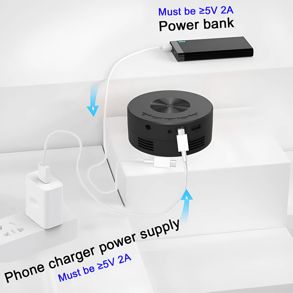Black mini portable projector for children with phone connectivity on a table.