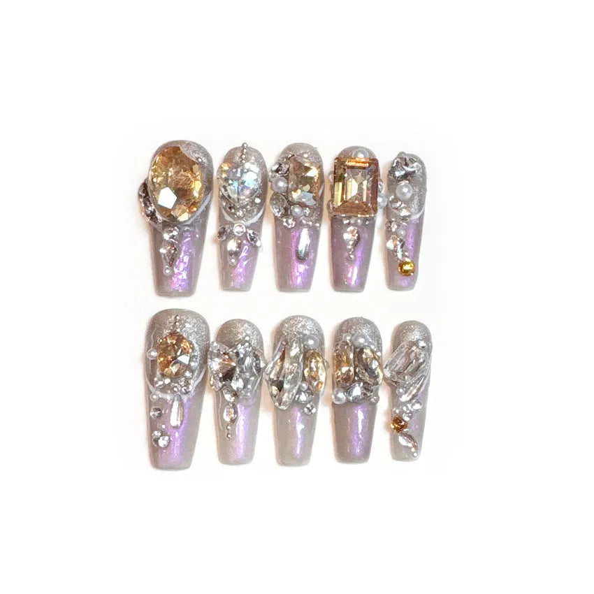 False nail patches with luxury rhinestone designs and phototherapy sealing layer on card packaging