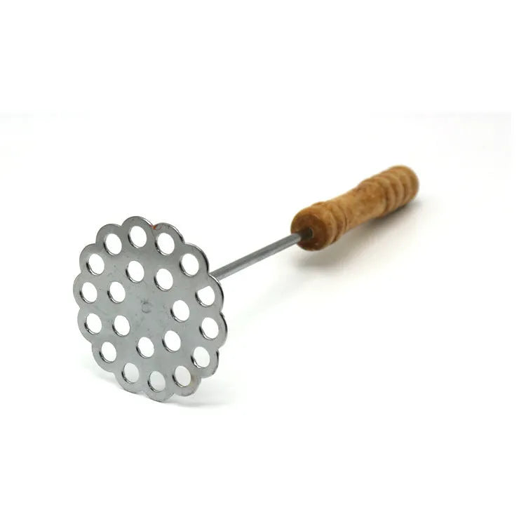 Manual potato masher with wooden handle and flower-shaped iron plated press head on a light surface