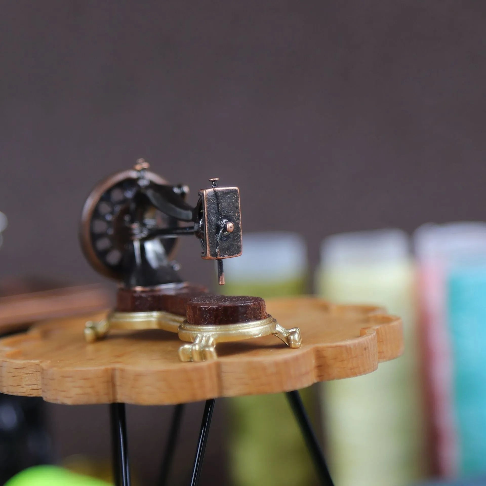 Brown metal simulation mini hand sewing machine dollhouse accessory on display
