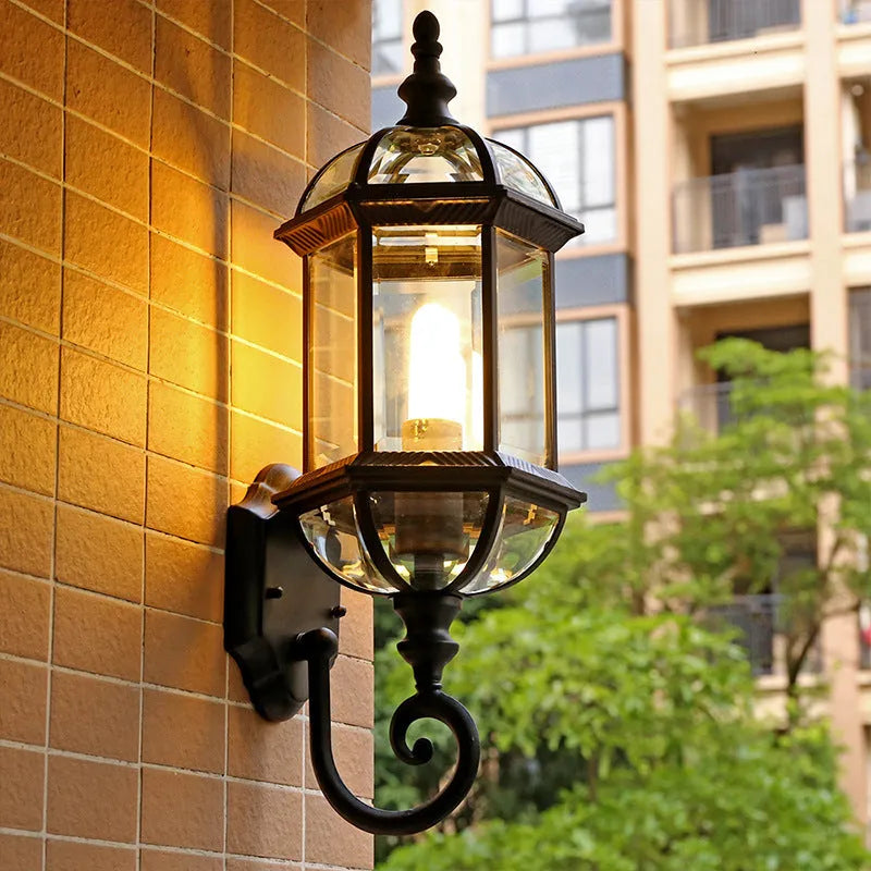 Outdoor aluminium wall lamp with three-layer design in black finish mounted on a courtyard wall