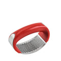 Stainless steel garlic press with curved ergonomic design and non-slip handle in assorted colours.