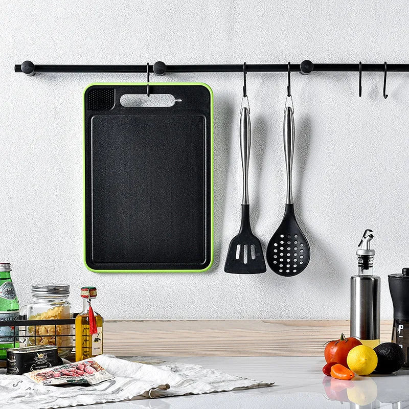Grey square aluminium cutting board with grinding teeth and integrated knife sharpener