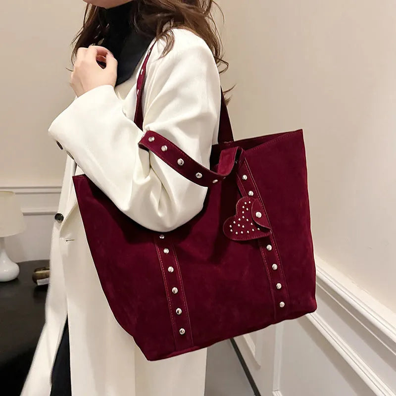 Black PU leather tote bag with double shoulder straps, showing interior sandwich pocket organiser.