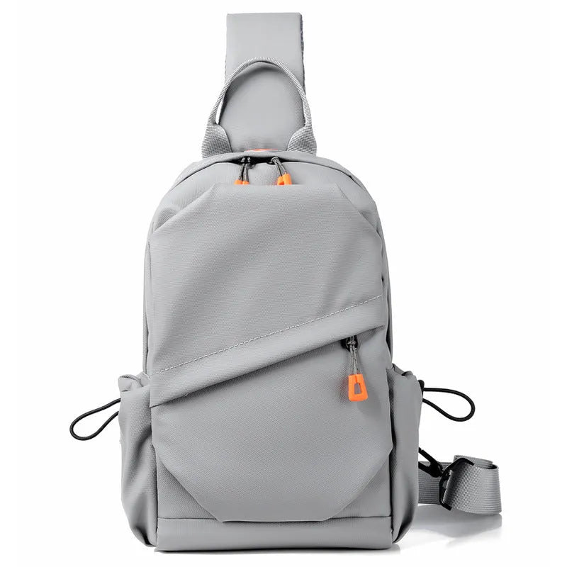 Men's black polyester crossbody bag with a single shoulder strap, shown in a casual setting.