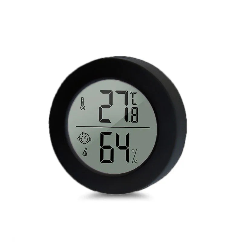 Round Smiling Face CX1030 digital temperature and humidity meter in white on a tabletop
