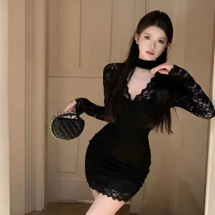 Women's black halter neck lace dress with A-line skirt and hip wrap sash on a model.