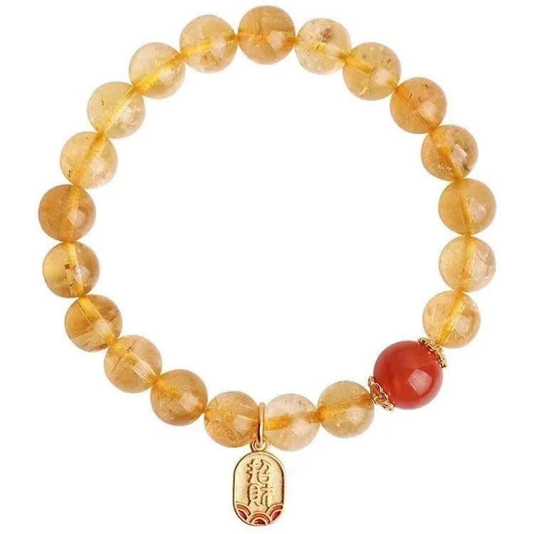 Red agate lucky bead bracelet with gold ruby accents showing polished natural stone beads