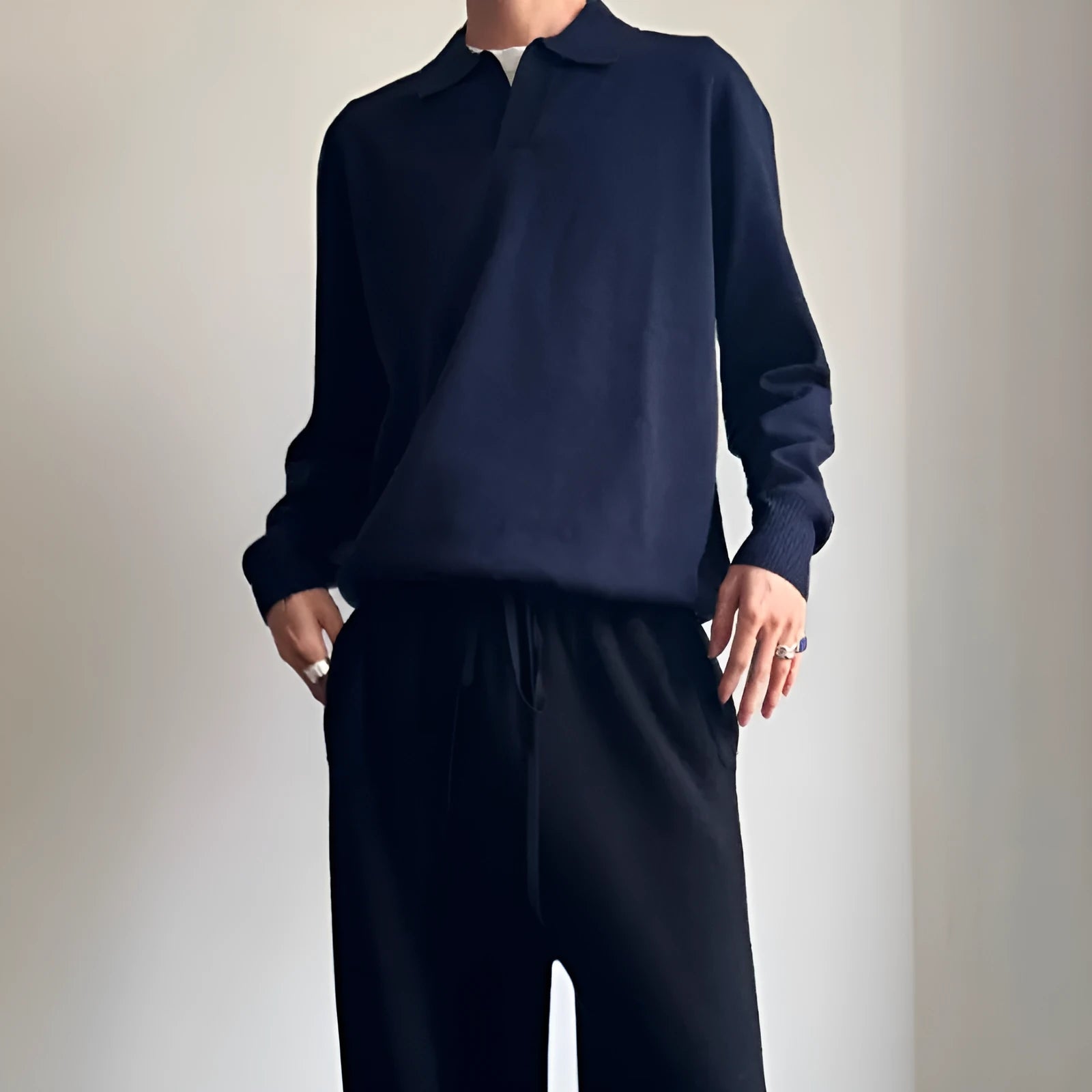 Pure wool polo sweater with a lapel collar in milky white, showing loose fit and long sleeves.