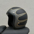 Glass fibre FRP retro half motorcycle helmet shown in a cement grey colour.