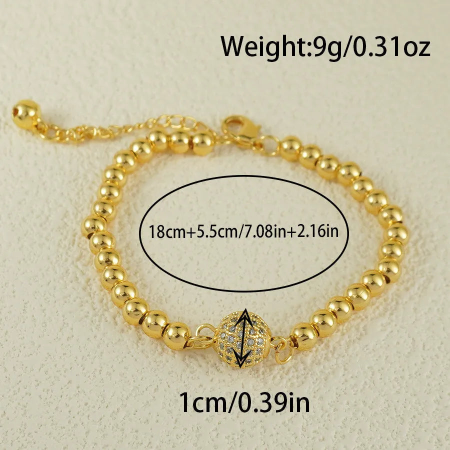 Close-up of a women's copper bracelet with a heart-shaped charm holding a round zircon stone, Arabic style design.
