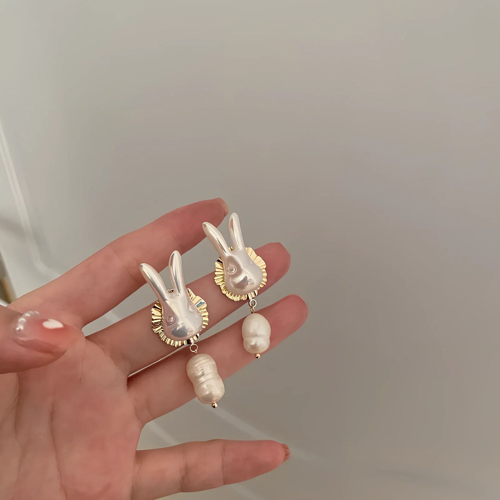 Silver bunny character earrings with baroque pearls measuring 2.5cm length with electroplated finish