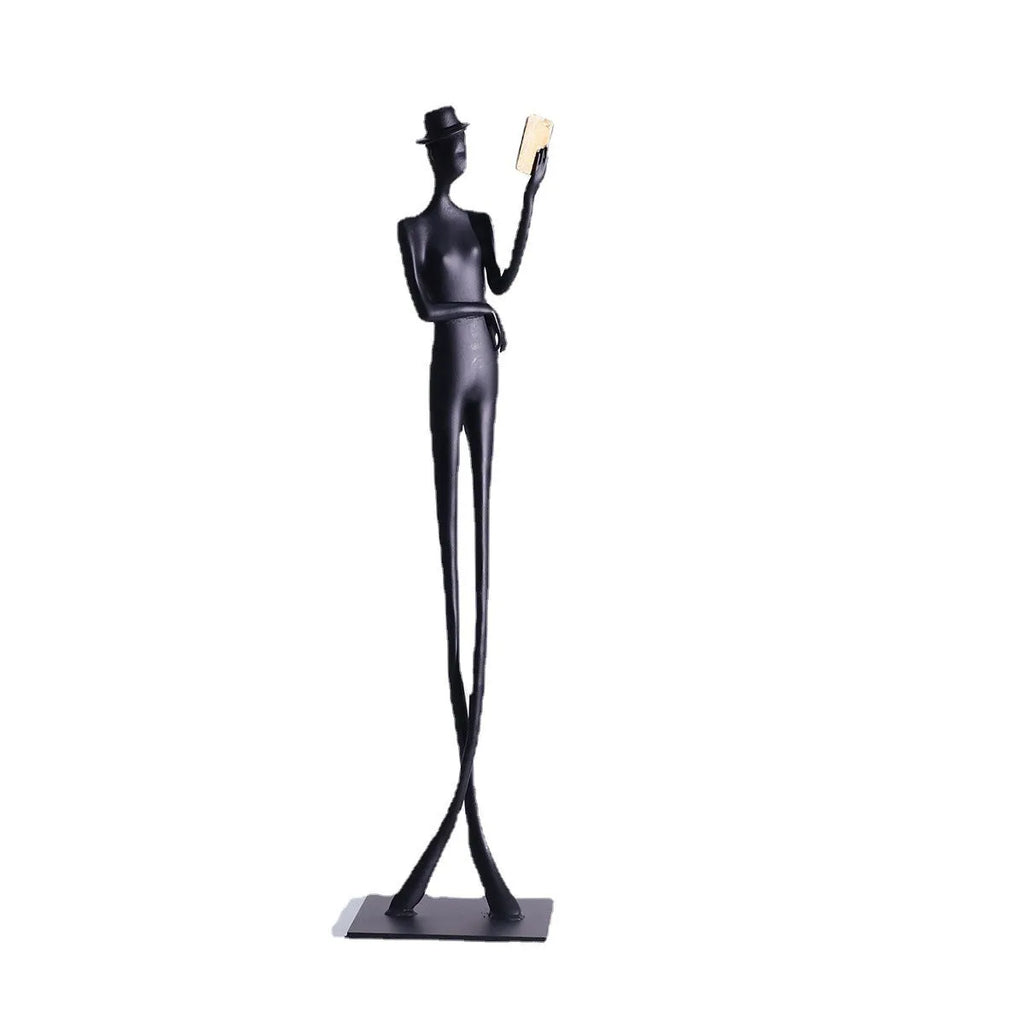 Black cast aluminium desktop sculpture of a woman reading, modern simplicity style, 51cm tall.