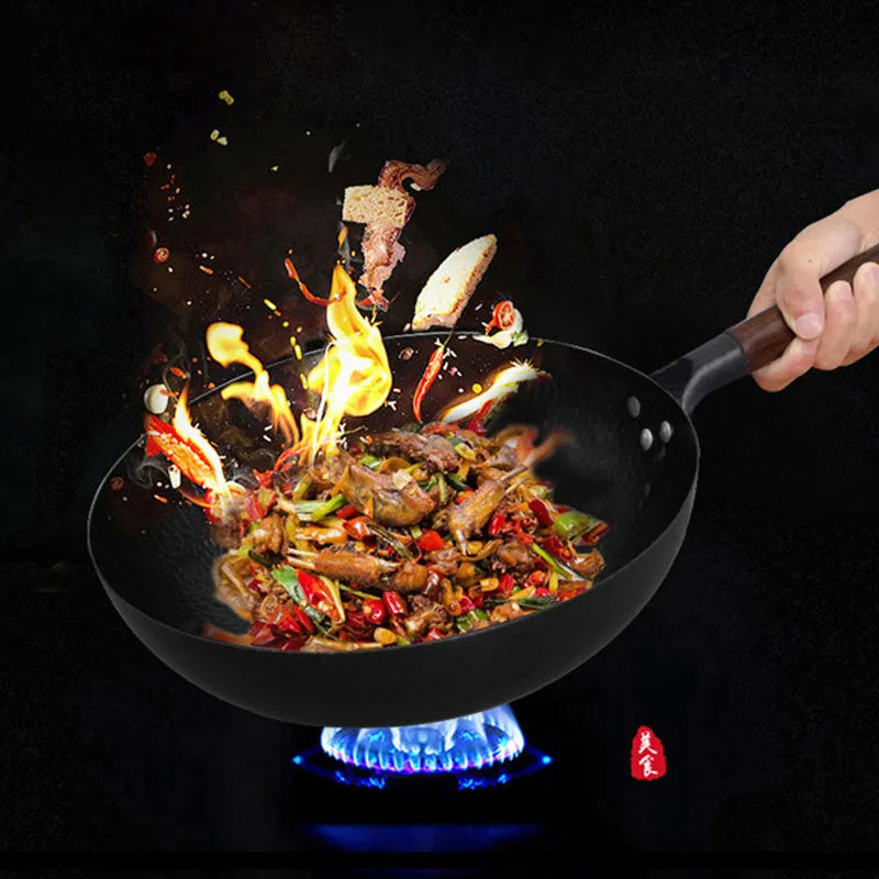 Traditional black iron wok pan with wooden handle measuring 40x32x10cm