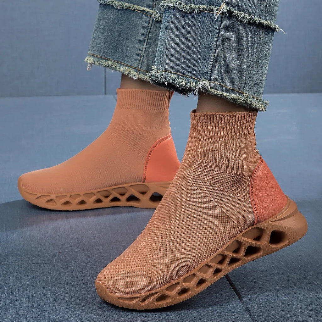 Women's terracotta coloured stretch mesh socks boots with flat heel and round toe on a white background.