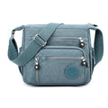 Lightweight grey nylon shoulder messenger bag with a single strap, shown in a square vertical shape.