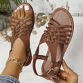 Roman style beach slippers with cross strap design and adjustable flat buckle in black
