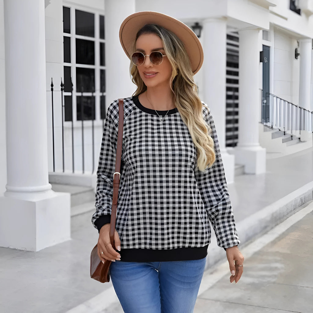 Black long sleeve pullover sweater with a printed plaid stripe pattern on a mannequin.