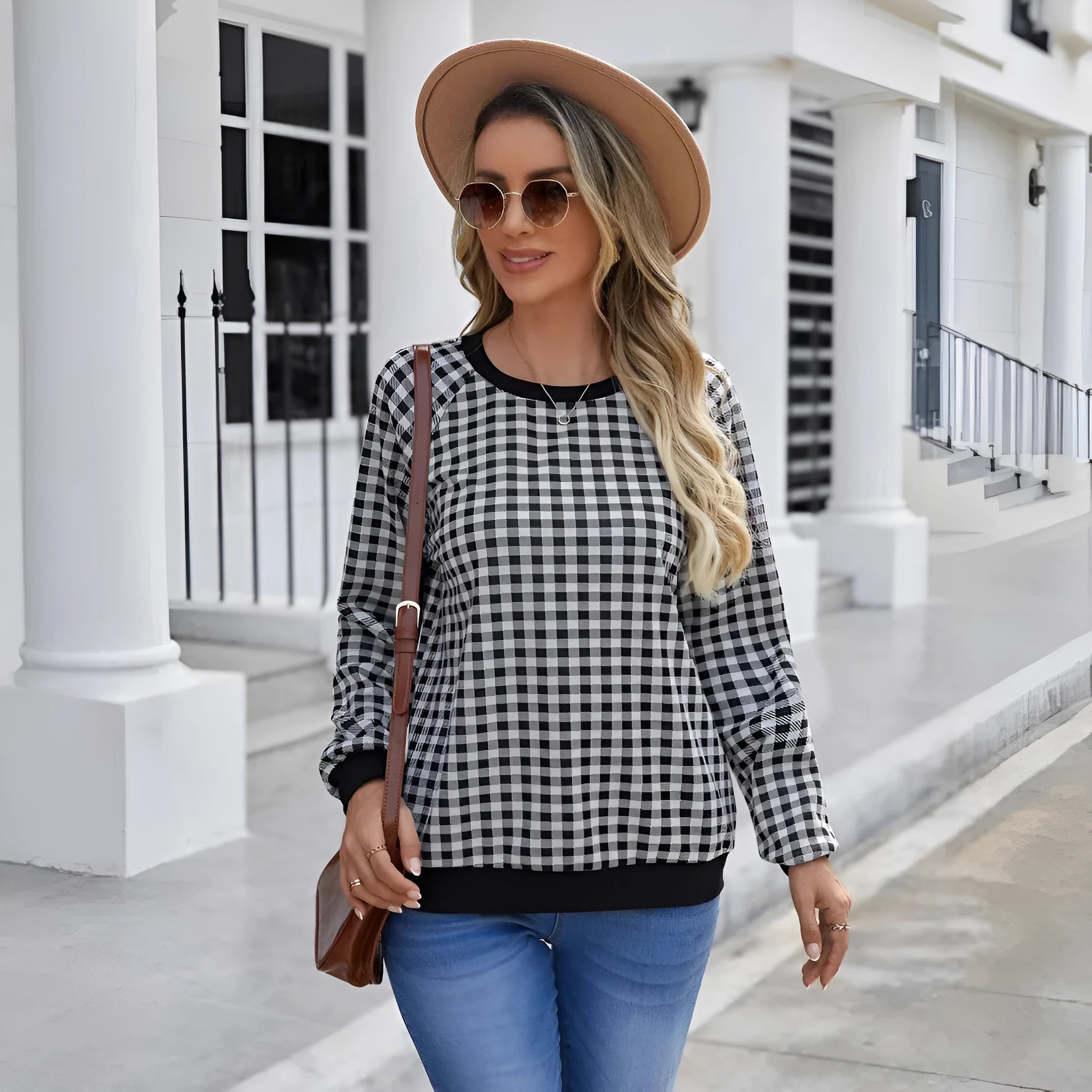 Black long sleeve pullover sweater with a printed plaid stripe pattern on a mannequin.