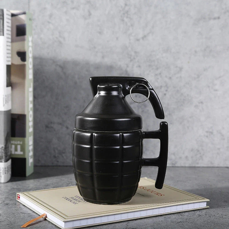 A grenade-shaped ceramic coffee mug with a lid, featuring a military-inspired design for a unique and tactical look.