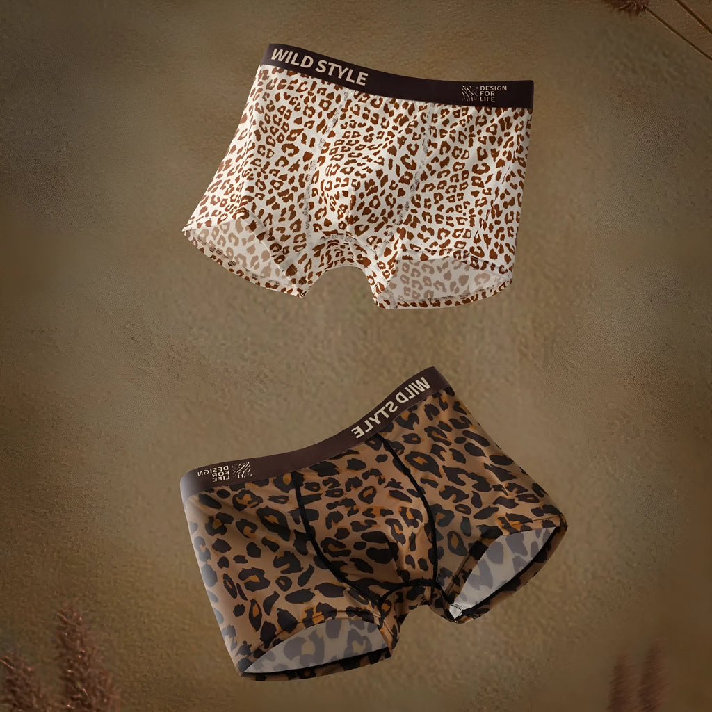 Men's leopard print ice silk underwear trousers in a folded display showing the mid waist design and patterned fabric.