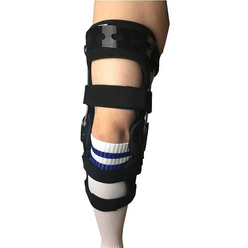 Black anterior ligament knee supporter with adjustable straps and hinge joints shown in size M-R format