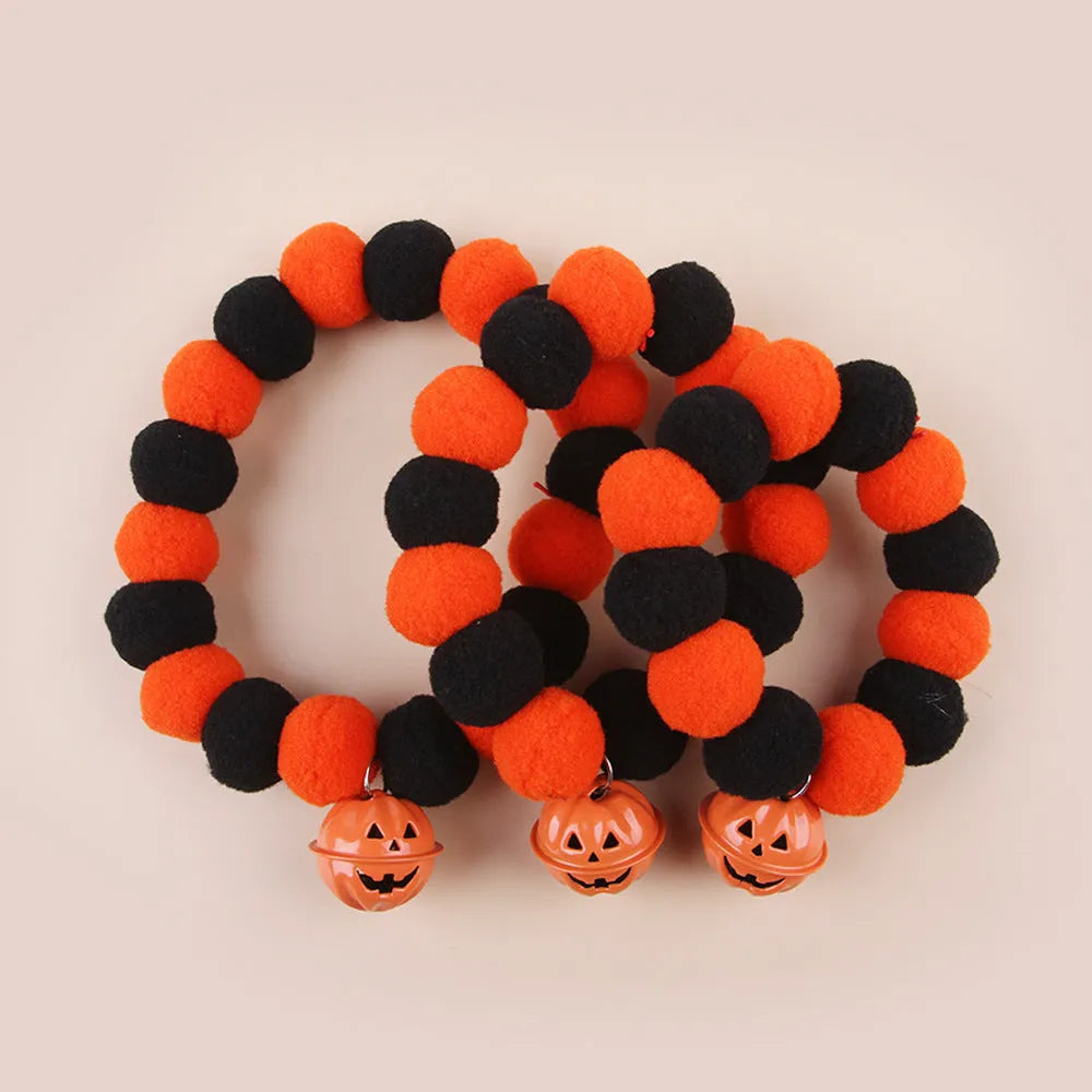 Orange Halloween pet collar with black trick-or-treat pumpkin design on a cat.