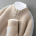 Plus-size model wearing a slim-fit, grey, half-zip wool sweater with a round neckline.