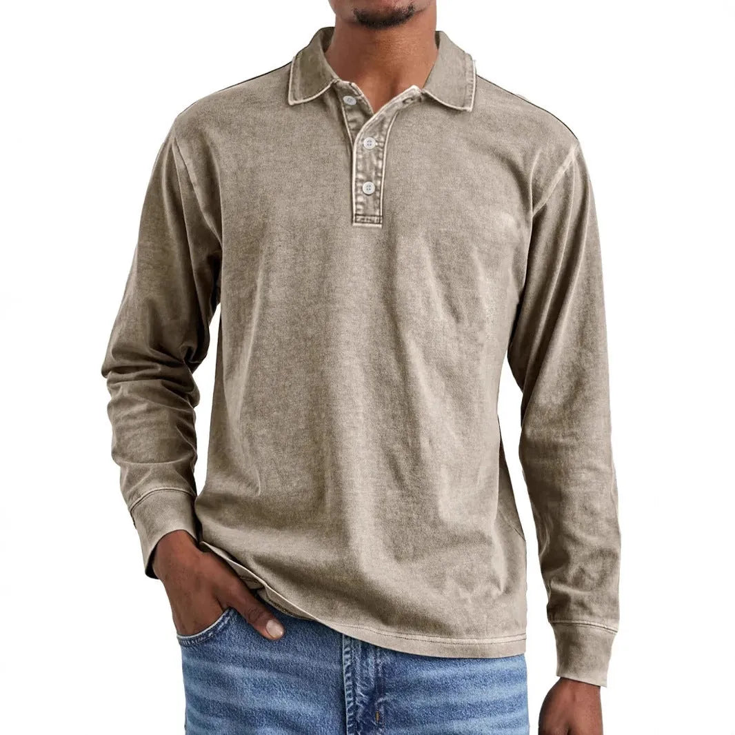 Man wearing a retro washed grey cotton polo shirt with distressed details and a lapel collar.
