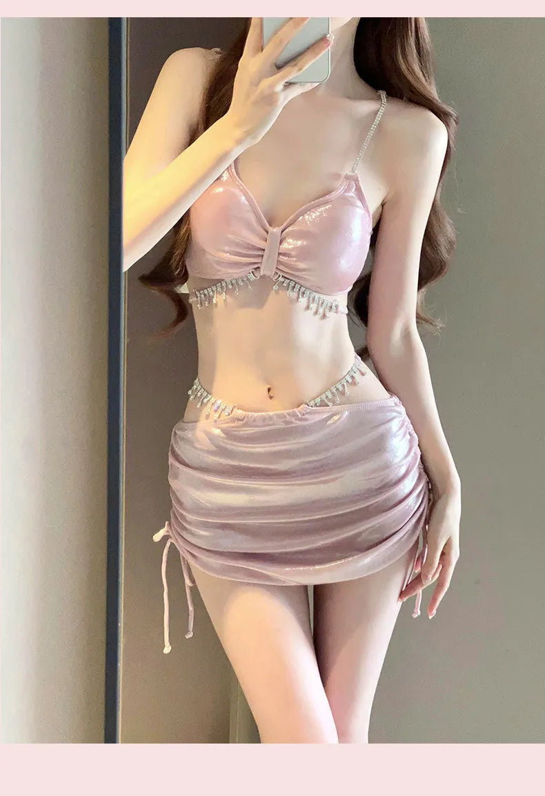 Women's solid colour pink and black polyester bikini swimsuit set on a white background.