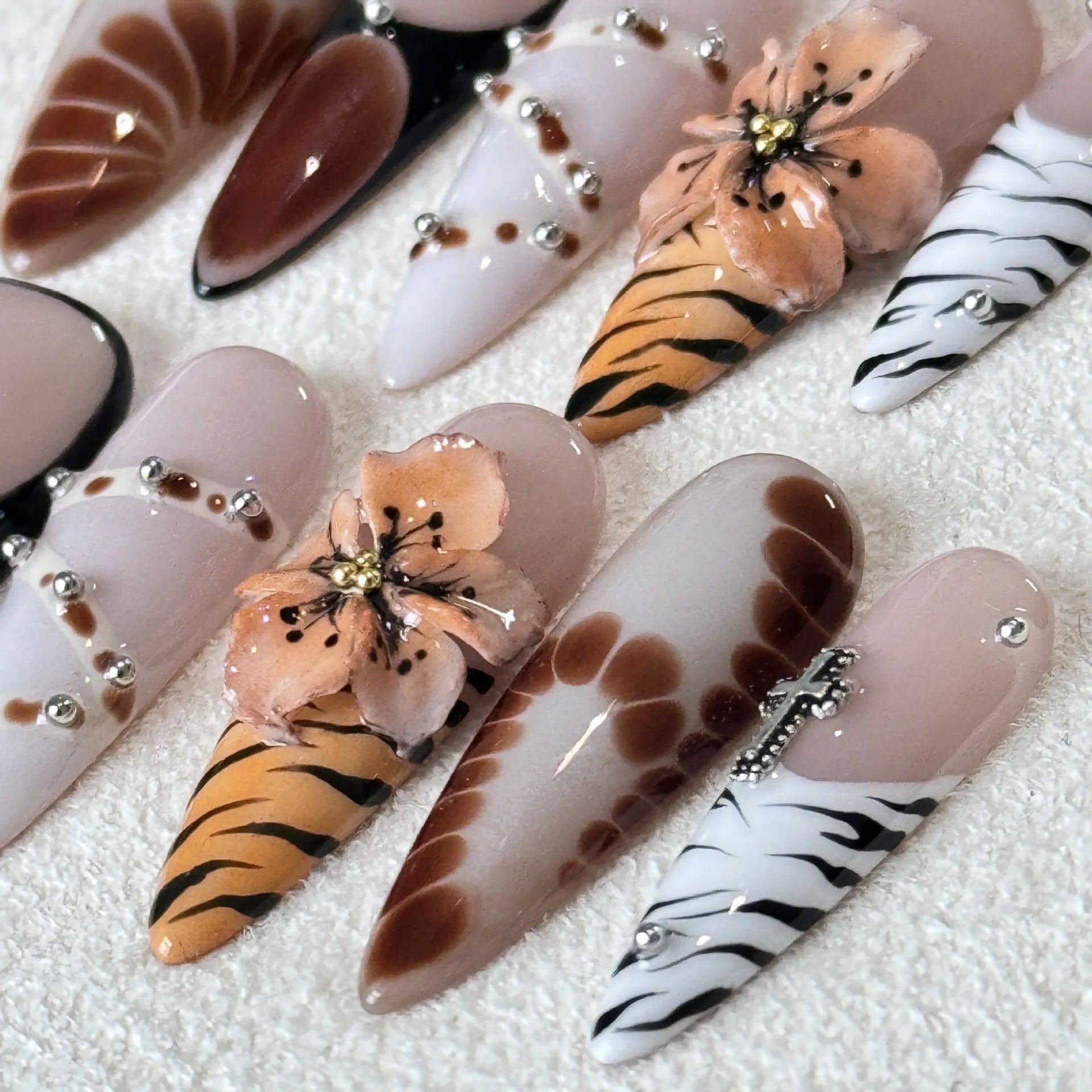 Pack of 10 leopard print, floral, and cross pattern nail stickers in sizes XS, S, M, L.