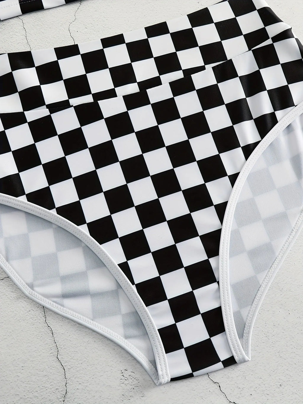 Women's black and white chessboard plaid racing one-piece swimsuit with a suspender backless design.