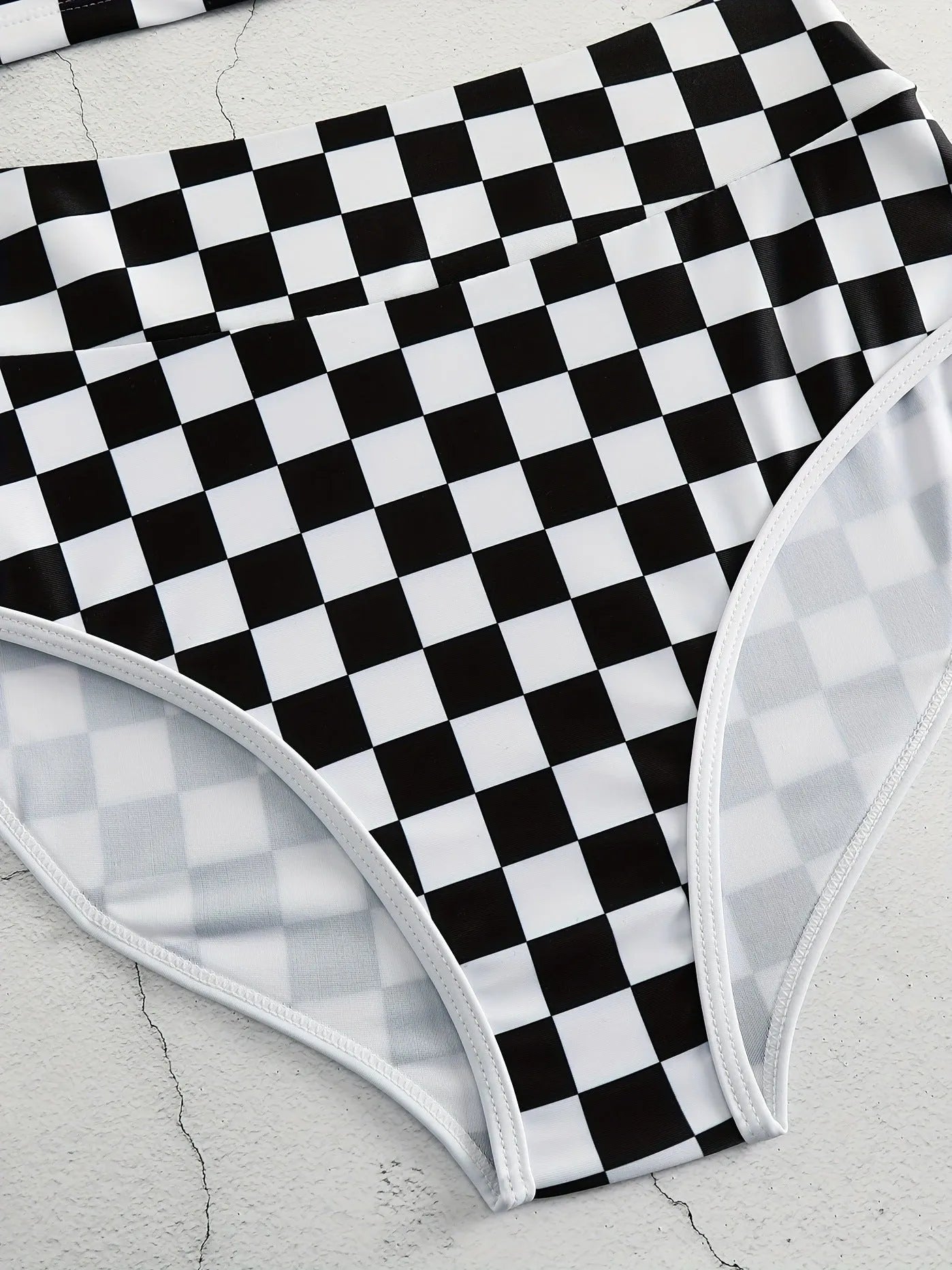 Women's black and white chessboard plaid racing one-piece swimsuit with a suspender backless design.