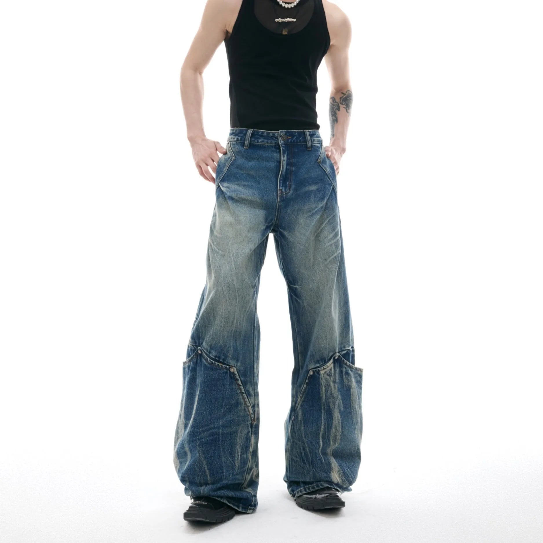 Men's verdant blue loose fit jeans with a washed burst pattern and curved knife leg style.