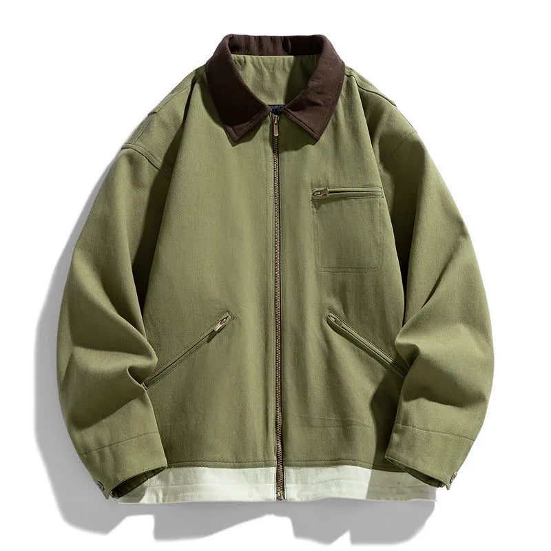 Man wearing a mint green loose retro workwear jacket with contrast lapels and side pockets.
