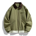 Man wearing a mint green loose retro workwear jacket with contrast lapels and side pockets.