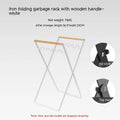 Foldable outdoor garbage storage hanger with iron frame and wooden handle in black colour.