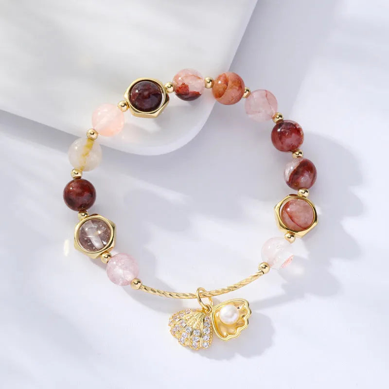A women's crystal bracelet with colourful hair crystal shells and a red sealant flower shell on an electroplated band.