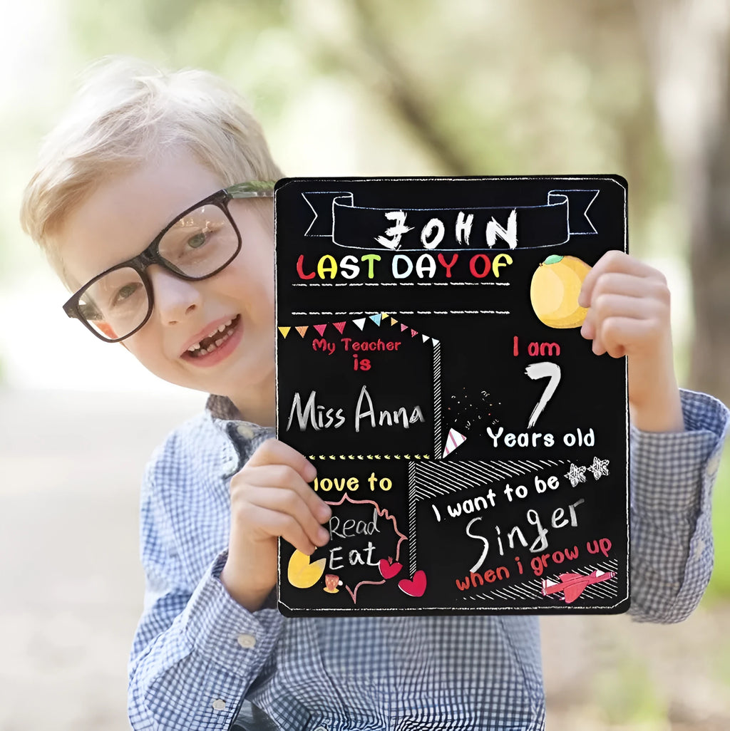 Black wooden First Day of School sign with white chalkboard text, measuring 25.5 by 30 centimetres.