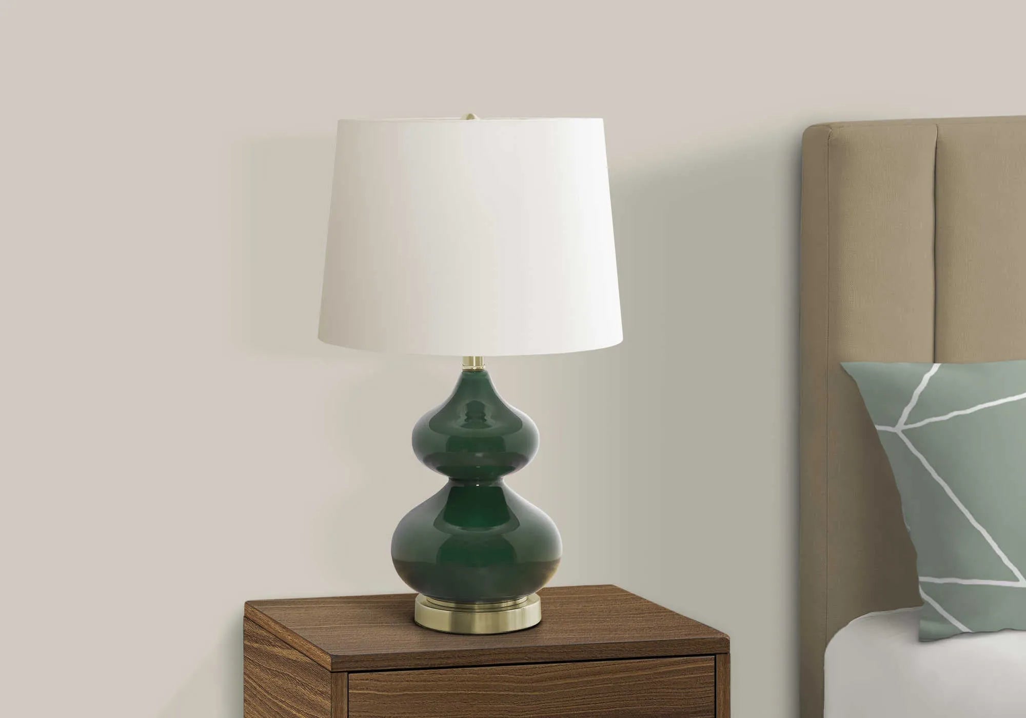 Blue crystal glass desk lamp with a white fabric shade on a wooden desk.