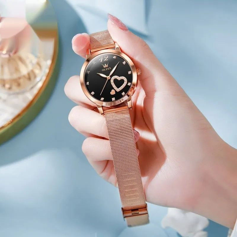 Women's rose gold alloy watch with a mesh strap, showing white, black, blue, red, pink, and green dial colour options.