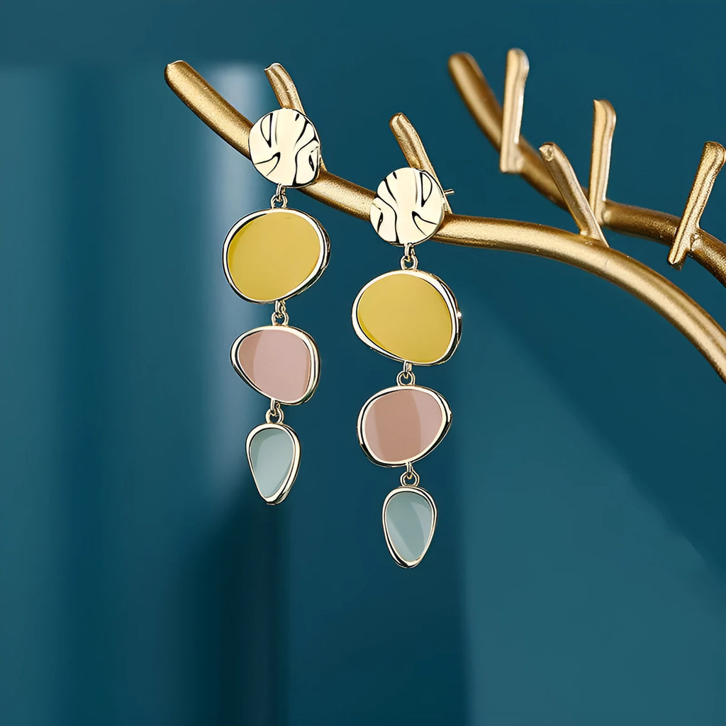 A pair of simple disc-shaped alloy earrings with a Morandi colour oil-drip finish on a sterling silver post.