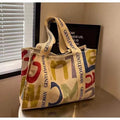 Large canvas women's tote shopping bag with printed design in choice of black letters, coloured letters, or pattern style.