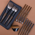 12-piece wooden handle makeup brush set with a powder brush in a grey PU pouch